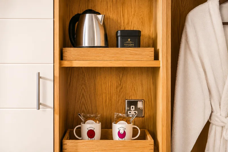 In-room tea and coffee facilities with bathrobe at North Lakes Hotel and Spa, Penrith